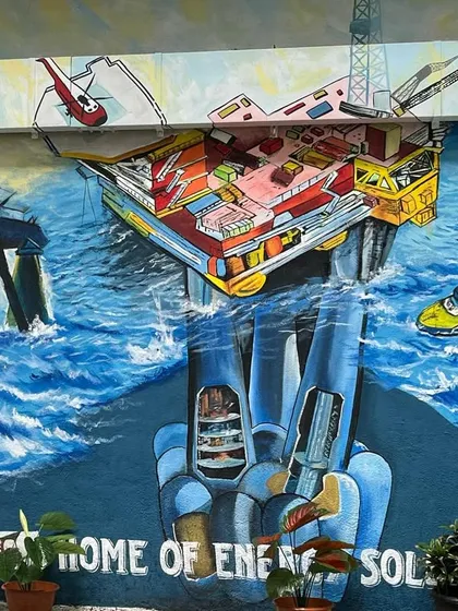 A detailed mural for ONGC in Panvel, depicting the complex world of offshore energy solutions with dynamic ocean waves and industrial structures.