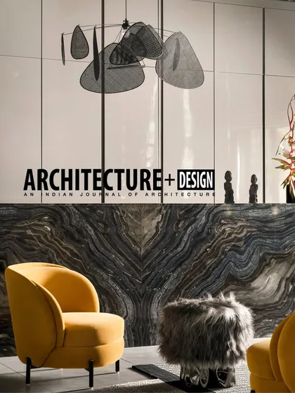 The Pool House project was also featured in Architecture+Design magazine. This image from the article highlights the bold material choices, like the dramatic marble bar and mustard yellow armchair.