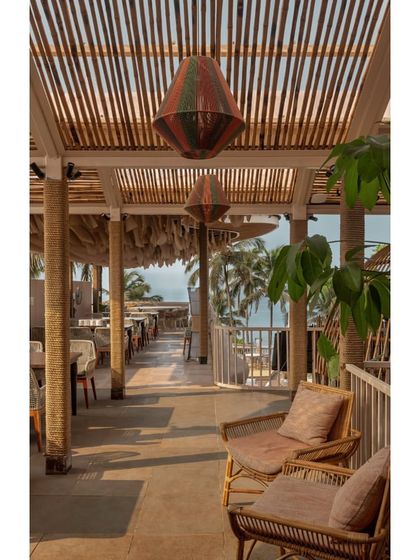 A seating nook at Dubki with custom-made light fixtures. The space is designed to feel cozy and intimate, offering a quiet corner to enjoy the view and the sea breeze.