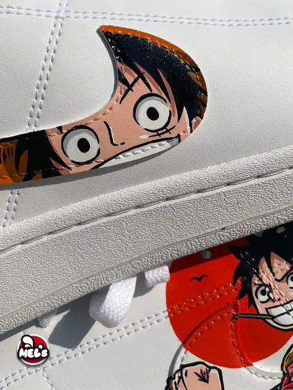 A close-up look at the creative swoosh design on our One Piece custom Nikes. We transformed the iconic check into Luffy's face, giving it a unique and playful twist that fans will instantly recognize.