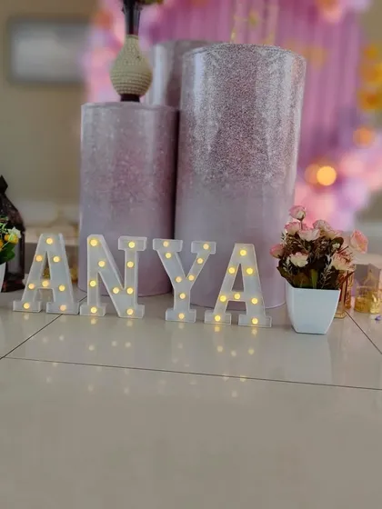 A close-up of the light-up letters spelling 'ANYA', adding a personal and warm touch to the decor.