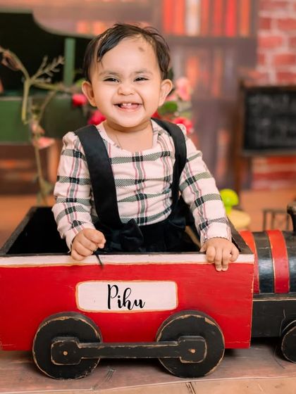All aboard the express train. This prop, set in our library-themed backdrop, is perfect for toddlers who love things that go. The name on the train can be customized for your child's shoot.