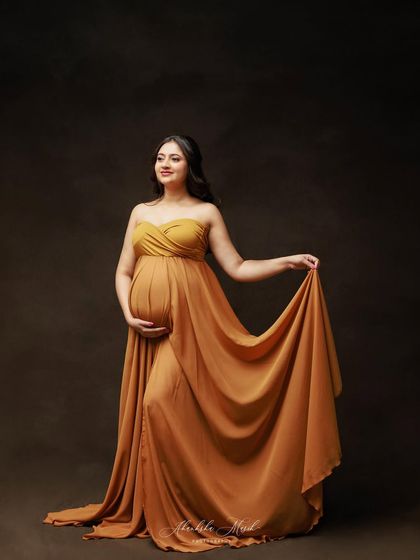 This flowing mustard-colored gown offers a warm and unique color choice, creating a portrait that is both earthy and elegant.