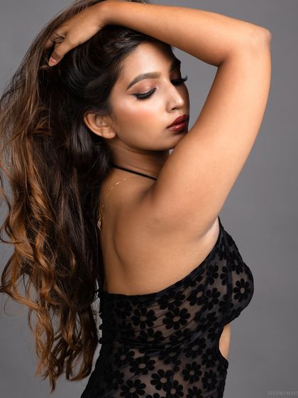 A profile shot of the model, with her hand in her hair, creating a sense of movement.