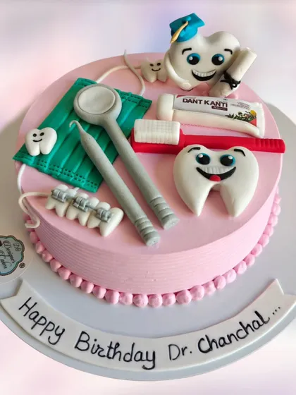 A fun and creative cake for a dentist's birthday. It's topped with edible dental tools, a toothbrush, and happy, smiling teeth characters.