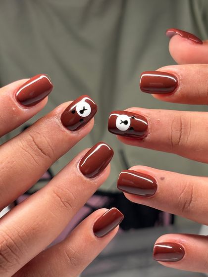 A fun shot showing the teddy bear accent nails. This is a great example of how I can add a touch of personality and fun to a simple manicure.