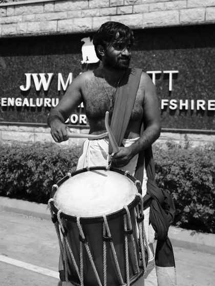 A black and white shot of our artist outside the JW Marriott, showing we perform at top corporate venues.