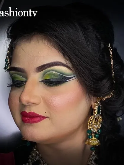 An example of advanced bridal eye makeup with a dramatic green and black cut-crease. Our course pushes you to master complex and artistic techniques for high-fashion bridal clients.