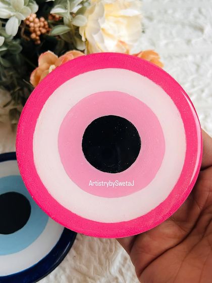 The pink evil eye coaster is a fun and modern twist on the traditional symbol, perfect for adding a pop of color to your decor.