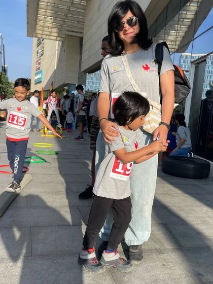 A mother and her children participate in an activity at the 'Walk in My Shoes' event. We believe in learning and growing together as a community.