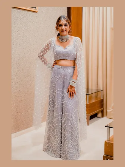 A beautiful full-length portrait of the bride in her stunning Sangeet outfit, showcasing her grace and style.