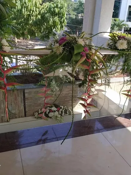 Floral decoration for a balcony or staircase railing. We use fresh flowers and cascading greenery to beautify different parts of the home for a cohesive look during your celebration.