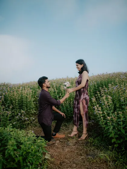 A proposal moment reenacted during a pre-wedding shoot in a beautiful field. This is a wonderful way to capture the memory of your engagement in a scenic location.