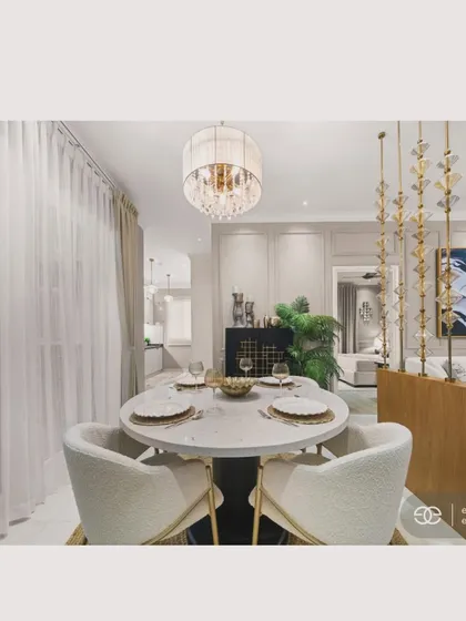 A mid-century modern dining setup, featuring an oval marble table and plush white chairs with gold accents. The elegant chandelier and sheer curtains create a sophisticated ambiance perfect for intimate gatherings.