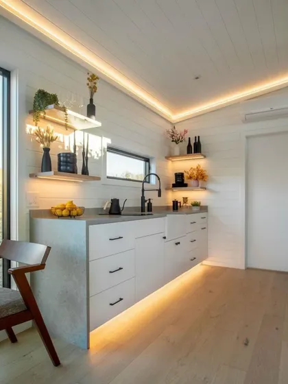 This stylish and compact kitchen demonstrates our commitment to smart design. It features a floating countertop, integrated appliances, and warm under-cabinet lighting, making it both beautiful and highly functional.