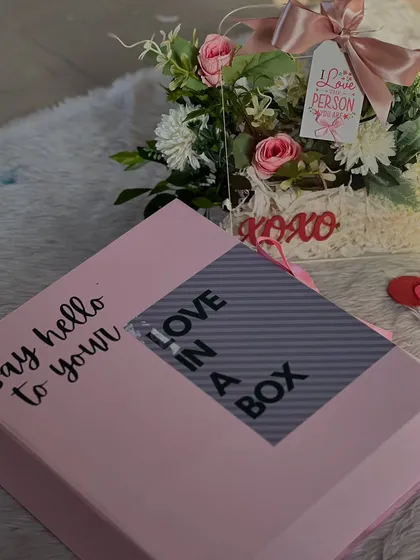 Say hello to your "Love in a Box." This Valentine's gift set comes with a beautiful floral arrangement, making it an extra special delivery.