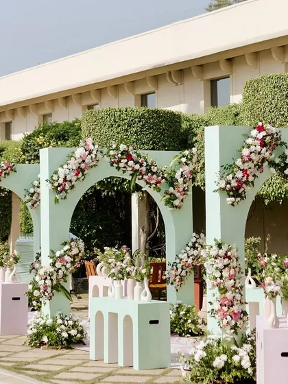 A wide shot of the mint green archway wall, which serves as a stunning architectural element and a beautiful backdrop for photos.