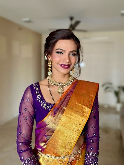 A happy and bright portrait. The makeup look is centered around a bold magenta lip and glowing skin, perfect for a festive wedding celebration.