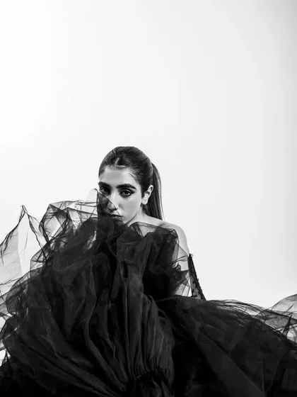 Monochrome strips away distractions, focusing on form, emotion, and drama. This high-fashion shot uses negative space and the flowing texture of the tulle to create a powerful silhouette. It’s an example of how I build a dramatic, elegant narrative with simple elements.