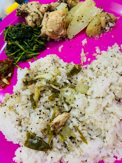 A simple but delicious plate with chicken, greens, chutney, and rice.