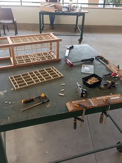 The process of building a Kumiko lamp, with the frame and panels laid out. This project was made by students from grades 6 to 8, proving that with patience, anyone can learn this craft.
