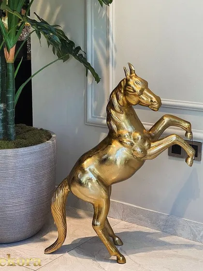This large, freestanding brass horse sculpture makes a powerful statement in any entryway or living space. The polished gold finish and dynamic pose capture the essence of equine grace, reflecting the high level of metal artistry from our workshop.
