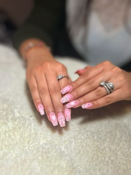 A soft pink set with white bow designs and glitter accents. This is a very sweet and feminine look.