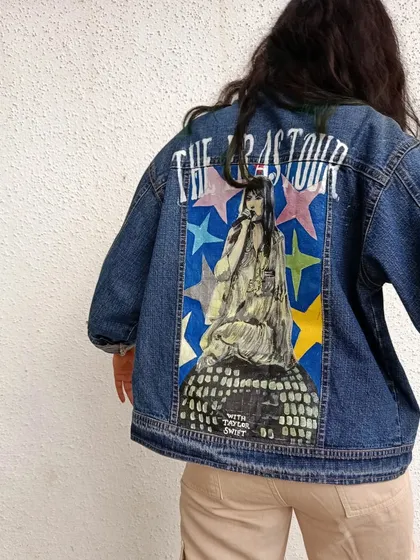 A clear, full shot of the back of the Taylor Swift Eras Tour jacket. I used a mix of bold colors for the stars and detailed brushwork for her portrait to make the design stand out.