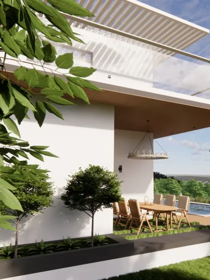 This view of the Snow Villa's patio, framed by native foliage, exemplifies our use of biophilic design principles. We strategically use plant life to soften architectural lines, enhance privacy, and create a serene connection with the natural environment.