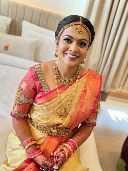 A happy bride ready for her big day. The makeup is natural and enhances her features, making her feel confident and beautiful.