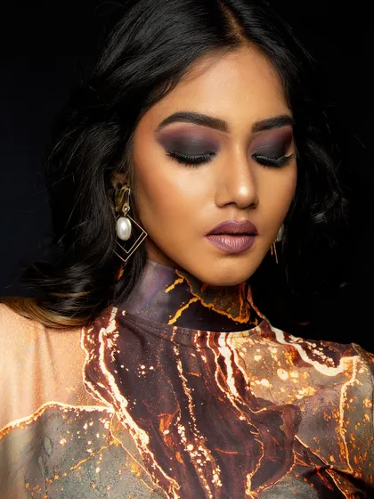 A moody and atmospheric portrait. The deep, matte smokey eye and muted lip color create a sophisticated and intense look, ideal for a fashion or commercial portfolio.