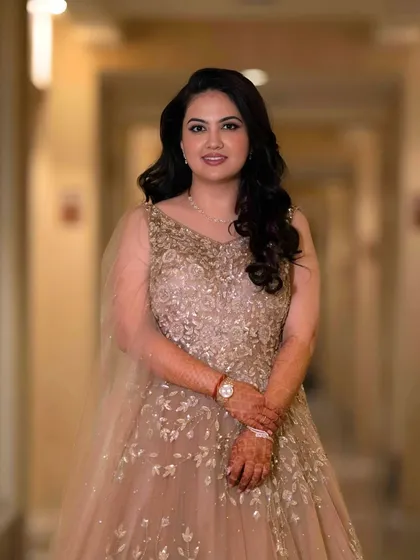 A full-length shot of the bride-to-be. Her makeup is minimal and radiant, perfectly complementing her embellished gown.