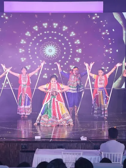 The energy of Garba is infectious. This is a moment from a large-scale stage performance, featuring vibrant traditional costumes and synchronized dandiya choreography that brings any celebration to life.