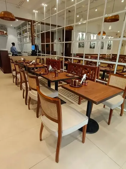 Another angle of the restaurant, highlighting the rows of custom-made dining chairs with cane backs and upholstered seats. Consistency and quality across a large order are things I guarantee for all my commercial projects.