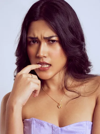 A more expressive shot from the same series. The makeup is soft and natural, allowing her personality to be the main focus.