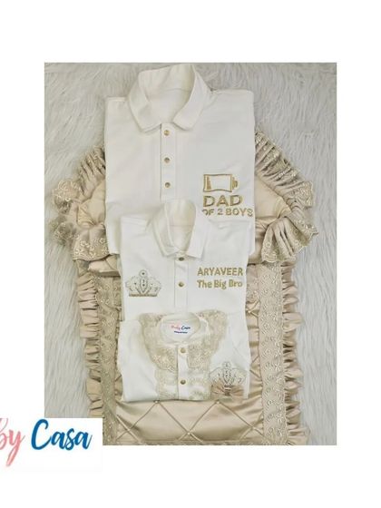 A complete family twinning set for a dad and his two boys. The outfits are coordinated in a beautiful beige and white color palette with custom embroidery for each family member.