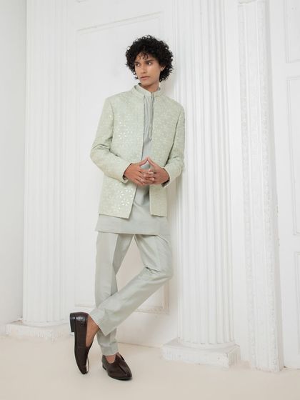 This tonal kurta set by Darshika Menswear is a masterclass in minimal elegance. The clean lines, subtle texture, and perfect tailoring make it a versatile and sharp option for any festive occasion, from a puja to a sangeet.