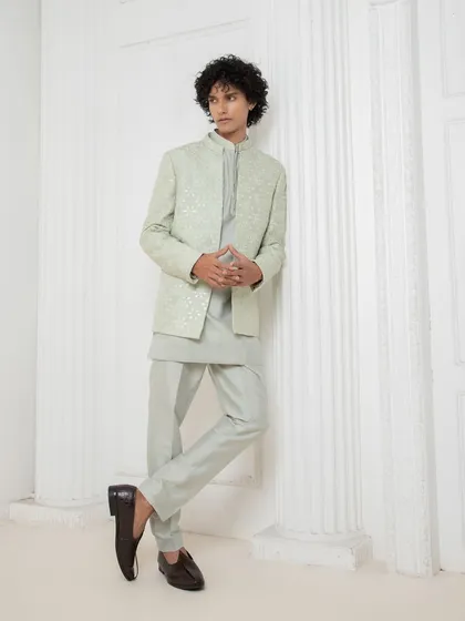This tonal green kurta set with a matching embroidered jacket is a masterclass in minimal elegance. It is a sharp and versatile look, crafted to perfection.