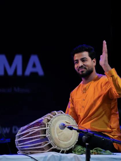 A gesture of gratitude to the audience after a fulfilling Pakhavaj piece.