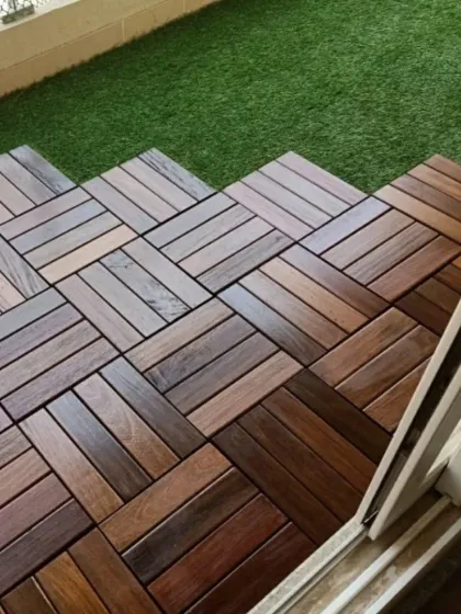 A close-up of the interlocking wooden deck tiles I use for balcony and terrace flooring. They provide a warm, natural look and are designed for durability and easy installation over existing surfaces.
