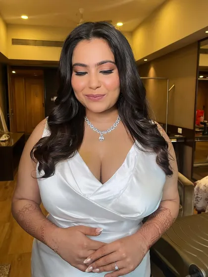 The bride with her eyes closed, showcasing the beautiful matte eyeshadow and clean liner. The look is sophisticated and chic.