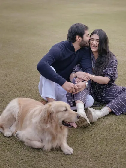 A casual and happy moment with Pragya, Adi, and their beloved dog, Malt. This pre-wedding shot shows their relaxed, fun-loving nature and the importance of their furry family member.