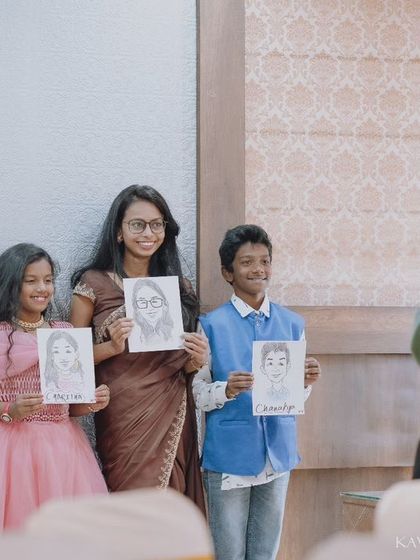 Capturing me in action. Here I am photographing happy family members showing off their portraits at an event, documenting the joy of the day.