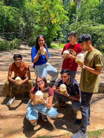 A group of friends enjoying fresh coconut water, the perfect natural refreshment after a day of activities.