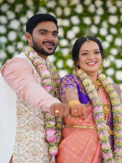 A joyful moment between the couple. The bride's radiant makeup look shines through, highlighting her happy expression.