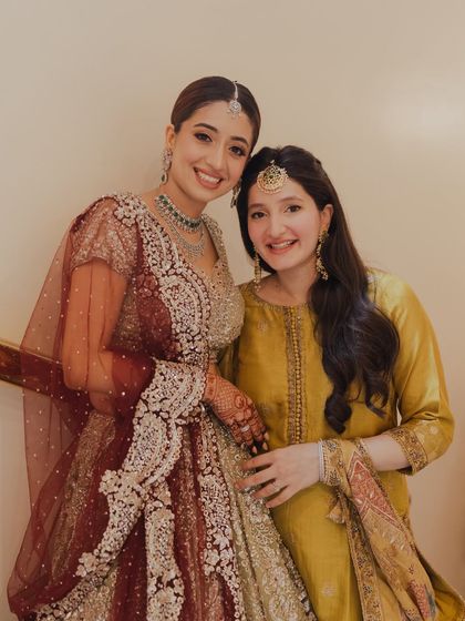 A heartwarming photo of the bride and her sister. I gave the sister a soft, natural look that complemented her beautiful yellow outfit.