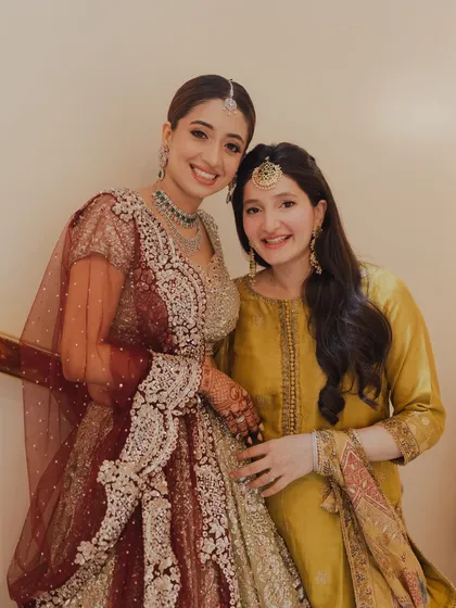 A heartwarming photo of the bride with her sister. Both are glowing, showcasing how I create complementary looks for the entire bridal family.