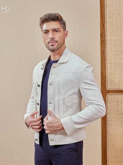 A full view of the white shacket, layered over a simple navy tee. It's a clean, modern look that elevates a casual outfit instantly.