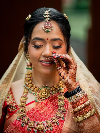 Another close-up, this time with a playful touch to her nose ring, her eyes sparkling.