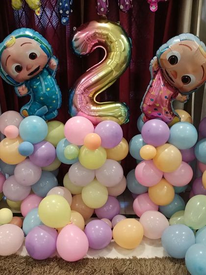 A closer look at the arrangement, showing the character balloons and the number '2' foil balloon.